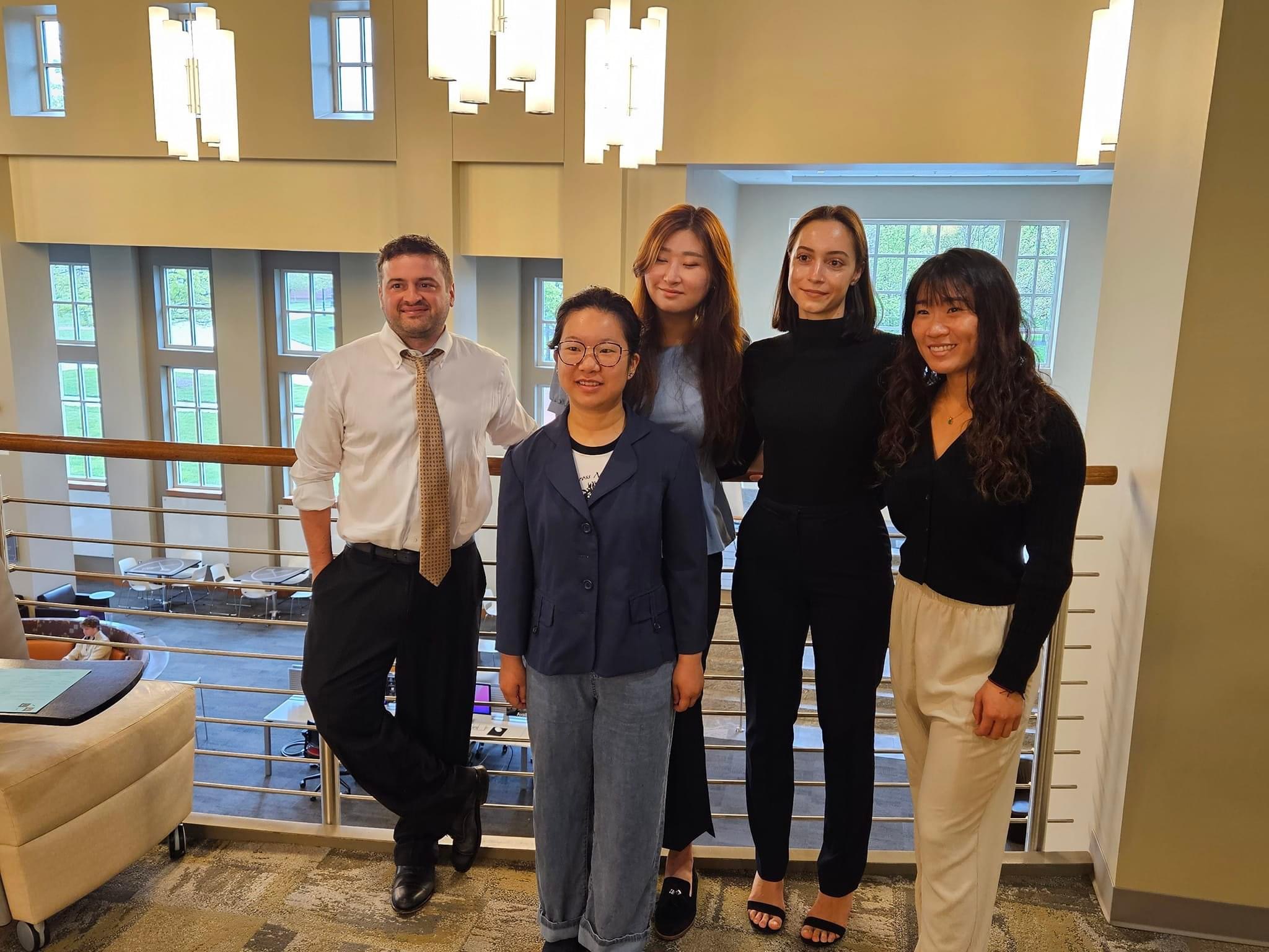 Professor Walter and four students in the Oxford Library after students presented research at the Oxford Research Scholars Symposium
